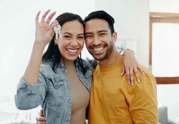 young couple holding keys to new house