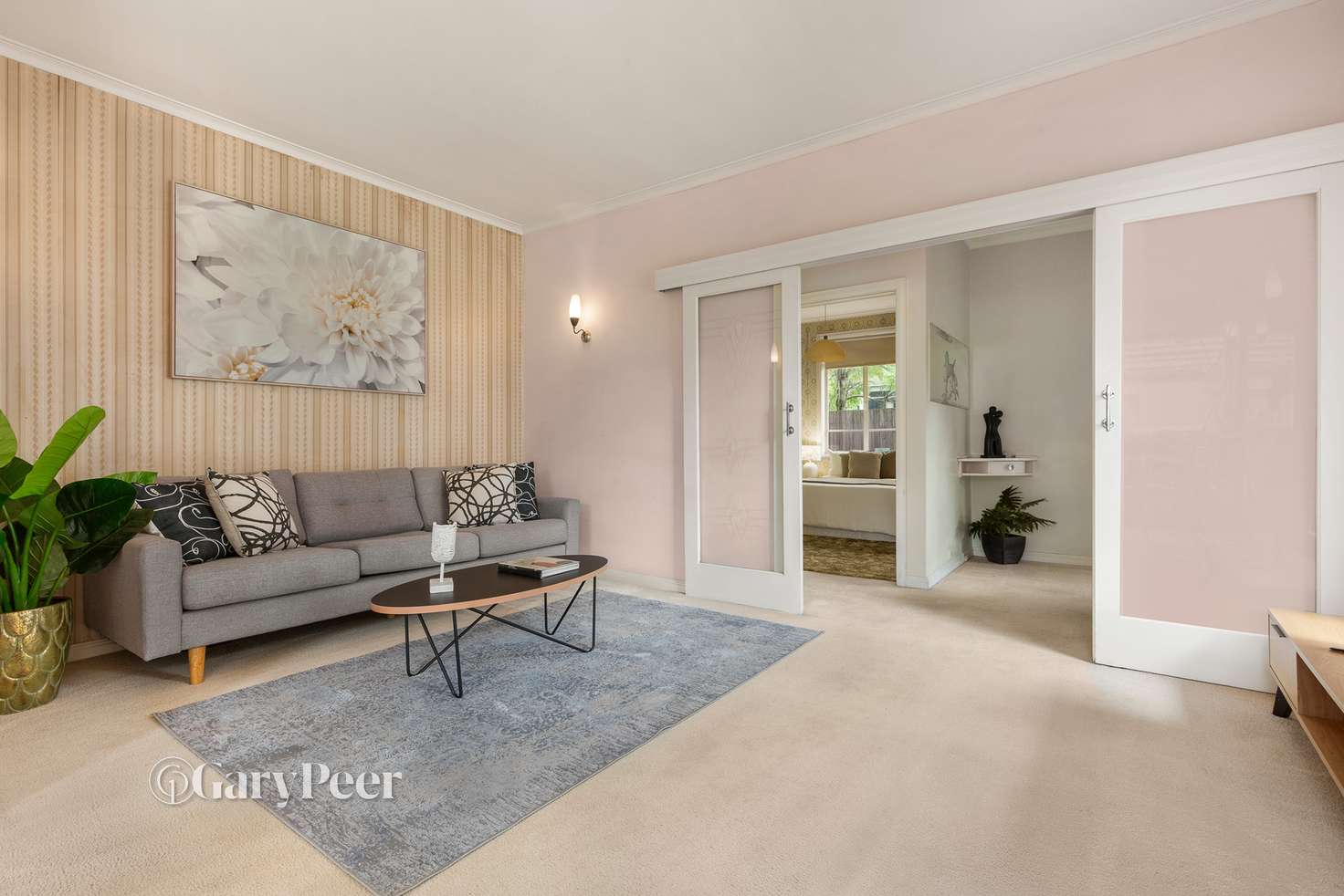 Pastel styled scandy-mid century style sitting room with muted pinks, creams and pot of pot plant colour 